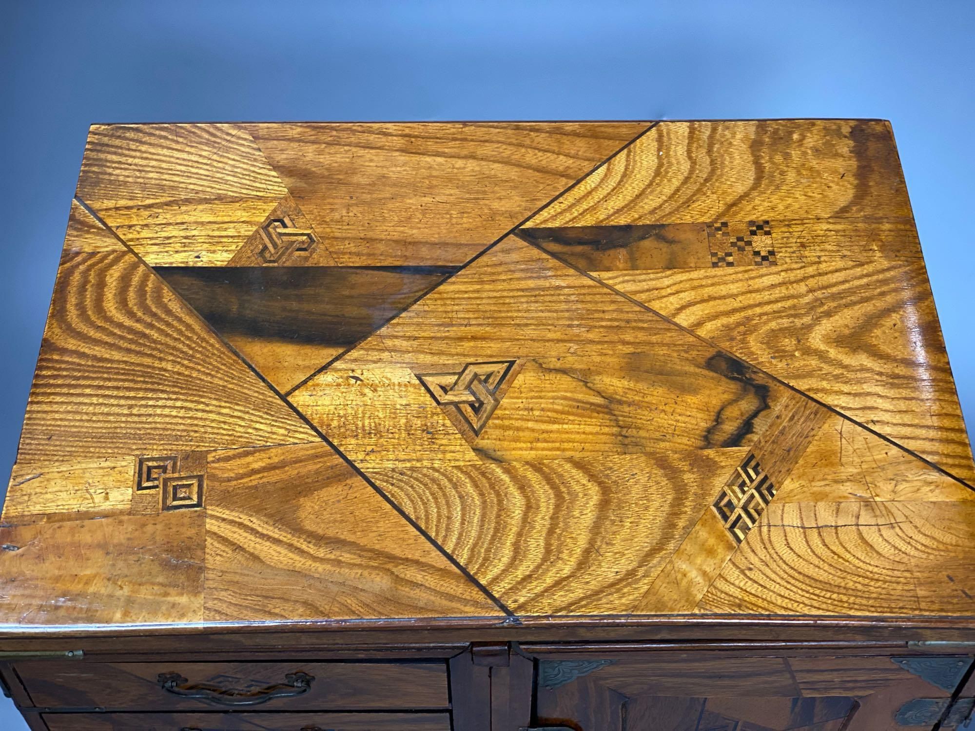 A Japanese metal mounted inlaid elm box with drawers, length 36cm